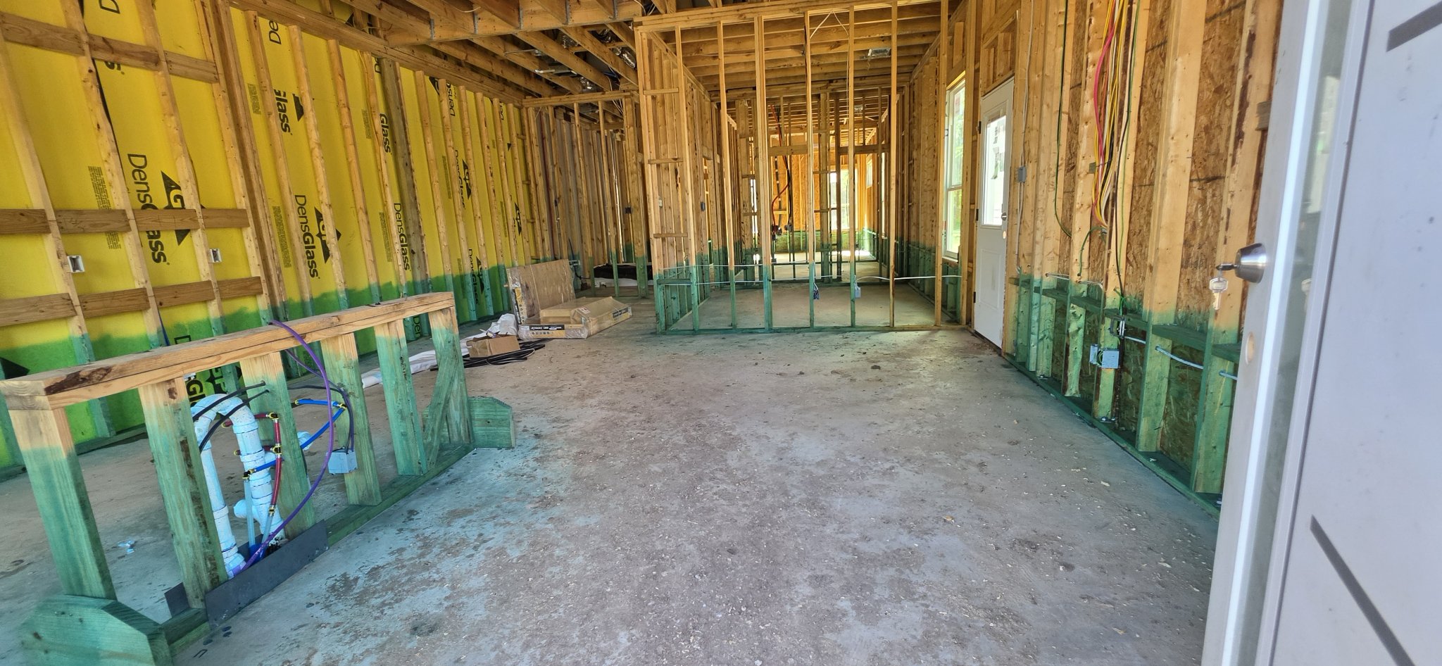 Wide view of exposed interior wall framing during new construction